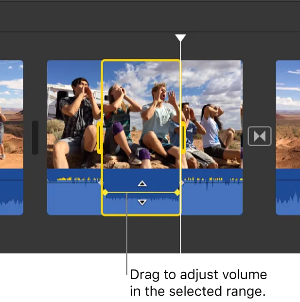 iMovie timeline with a yellow range selection and the audio volume line lowered within the selected range